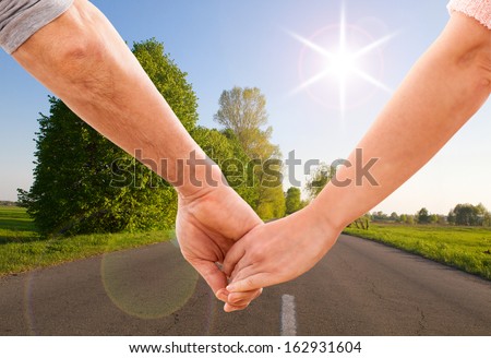 Happy couple holding hands close up