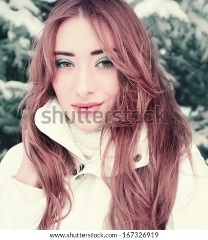 Outdoor winter portrait of young sensual brunette. Winter Beauty Woman. Christmas Girl Makeup. Holiday Make-up.