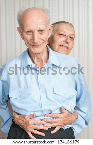 Closeup portrait of  smiling elderly couple Old people holding hands.
