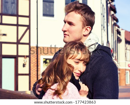 Portrait of Beautiful Young Couple in Love romantic trip to Europe. Man and Woman Smiling Charmingly. Young Couple Kissing Summer on Sunny Sky Background