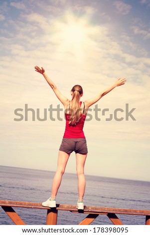 Free Happy Woman Enjoying sunset on Sea Beach. Available raised his Hands to heaven, Concept of Freedom, Enjoyment. Beauty Girl Sports, Fitness, Zen Outdoors. Beautiful Nature, Sunny Summer day Clouds