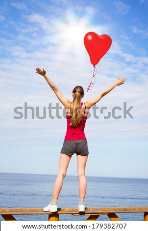 Free Happy Woman Enjoying sunset on Sea Beach. Available raised his Hands to heaven,  Woman\'s hand reach for sky, prayer, worship, praise, admiration. ?oncept of peace, tranquility, love. Red balloon.