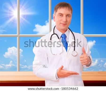 Doctor holding an empty hand showing thumbs up. Concept of medicine, health care, diagnostics.
