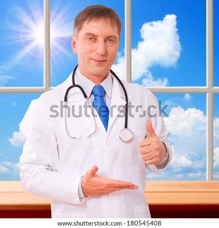 Doctor holding an empty hand showing thumbs up. Concept of medicine, health care, diagnostics.