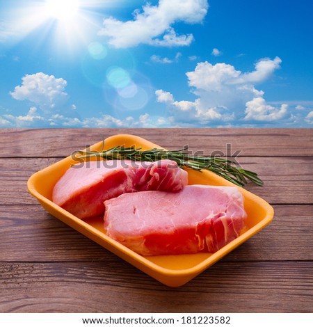 Raw meat for barbecue on wooden surface. Raw meat steak. Food , spices for cooking meat.