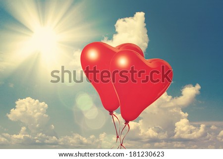 Sky background with the fluffy white clouds closeup. Retro love balloons on blue sky