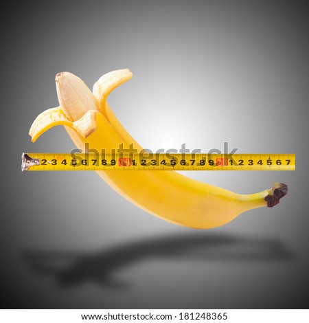 Large banana and measuring tape as image of man\'s penis