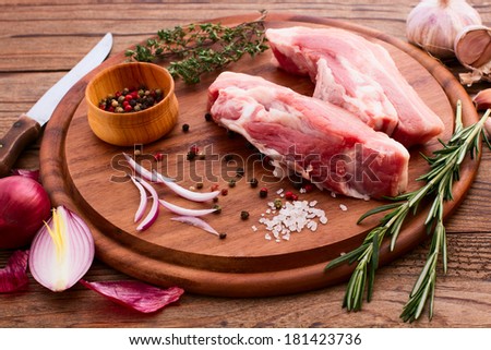 Raw meat for barbecue with fresh vegetables wooden surface. Food, meat raw steak, beef steak bbq, spices for cooking meat.