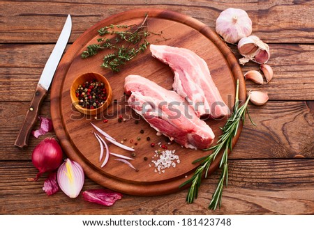Raw meat for barbecue with fresh vegetables wooden surface. Food, meat raw steak, beef steak bbq, spices for cooking meat. Free space for text.