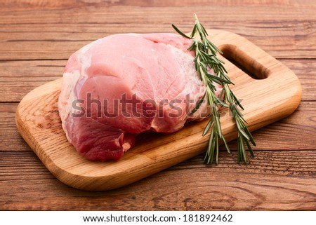 Sliced pieces of raw Meat for barbecue on wooden surface, menu cooking recipes. Food, raw steak, beef steak bbq, tomatoes, peppers, spices for cooking meat.