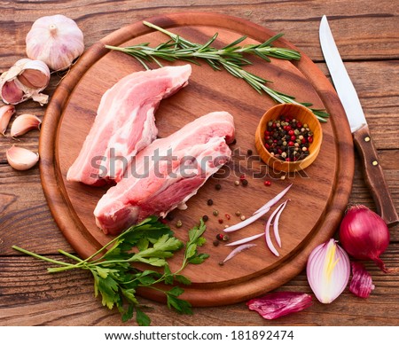 Food, sliced pieces of raw Meat for barbecue on wooden surface, menu cooking recipes. Food, raw steak, beef steak bbq, spices for cooking meat.