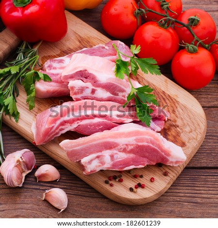 Food. Sliced pieces of raw meat for barbecue on white surface. Meat raw steak. Beef steak bbq.  Spices for cooking meat.