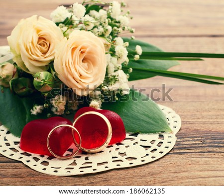 Bridal bouquet of white flowers on wooden surface. Summer wedding day, unusual designer florist bouquet of delicate roses. Free space for text.