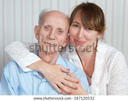 Senior man, woman with their caregiver at home. Concept of health care for elderly old people, disabled.  Elderly man, woman. Couple love