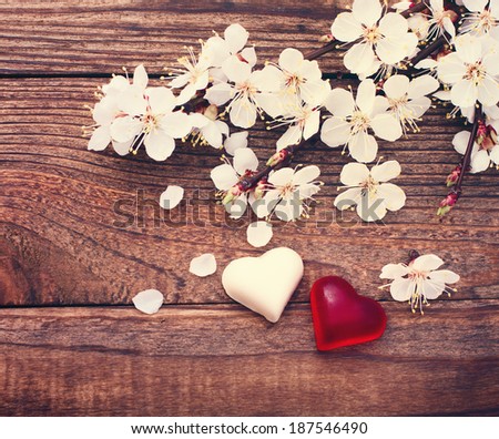 Flowering branch with white delicate flowers on wooden surface. Declaration of love, spring. Wedding card, Valentine\'s Day greeting.  Wedding bouquet, background. Empty wooden tabletop