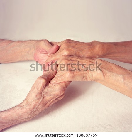 Old people holding hands closeup. Care is at home of elderly. Happy elderly couple man woman