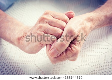 Care is at home of elderly. Old people holding hands. Closeup. Elderly man.