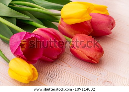Colorful spring flowers bouquet tulips  on wooden background. Mother\'s Day holiday, birthday, beautiful background for card