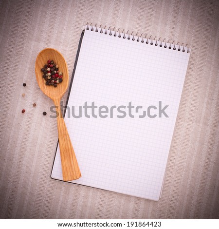White notebook on the surface of hydrochloric tablecloths and spices for food .