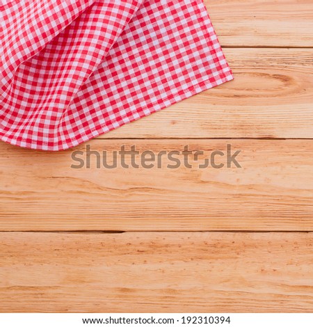 For recording menu, recipe on red checkered tablecloth tartan on wooden kitchen table close up view from top