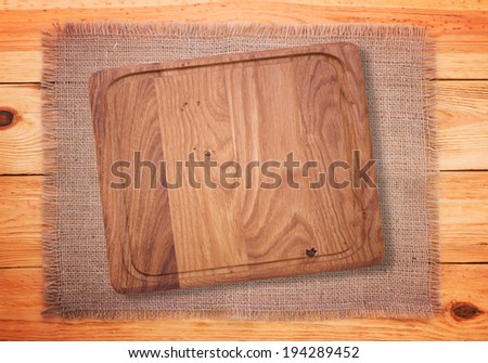 Cutlery on red checkered tablecloth tartan. Wooden table close up view from top. Wooden kitchen cutting board retro. Product pages for installation recipe books menu