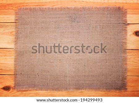 Page for the menu, recipe. Wooden table with a tablecloth texture top view.