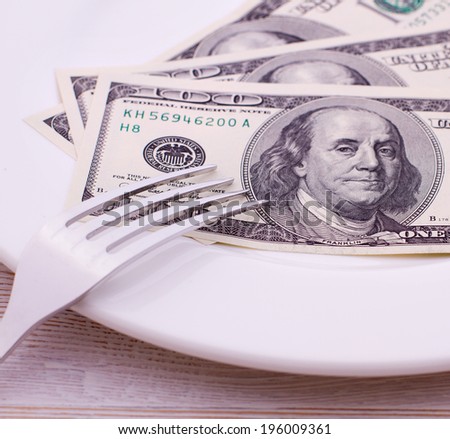 Cash dollars lying on the plate. Concept you want to eat - go to work