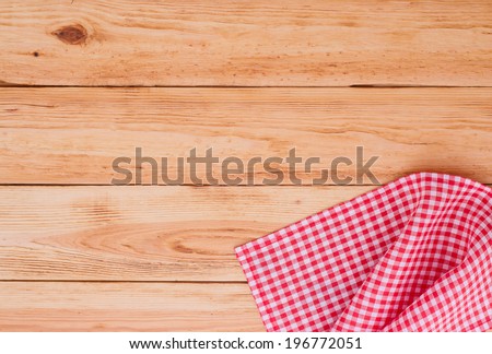 Wood texture  background. Wooden table covered with tablecloth cloth checkered plaid red. View from top. Empty tablecloth for product montage for recording menu, recipe. Free space for your text