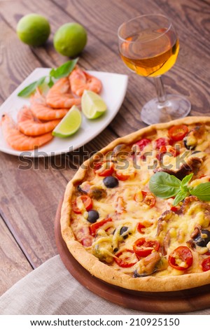 Pizza with seafood. Seafood Italian Pizza slice on wood dish (originality). Italian kitchen. Studio.