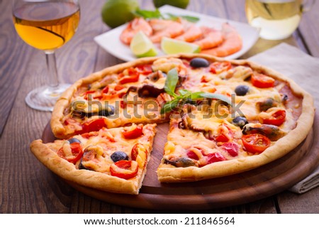 Pizza with seafood. Seafood Italian Pizza slice on wood dish (originality). Italian kitchen. Studio.