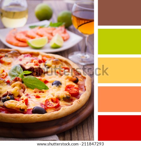 Pizza with seafood. Seafood Italian Pizza slice on wood dish (originality). Italian kitchen. Studio. Background color palette with complimentary color swatches.