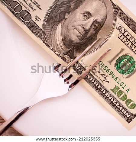 Money cash dollars lying on the plate. Concept you want to eat - go to work.