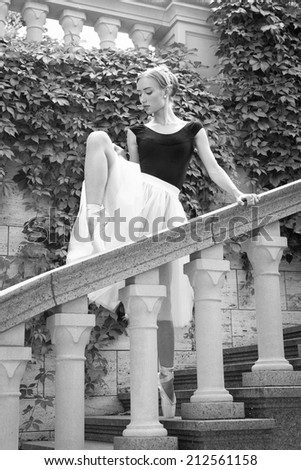 Art ballet. Beautiful young ballerina posing on emotional nature. Marble interior. Original unusual positions.
