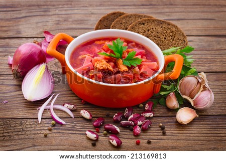 Ukrainian and Russian national Red Borscht on wooden surface, menu cooking recipes. Food, spices for cooking.