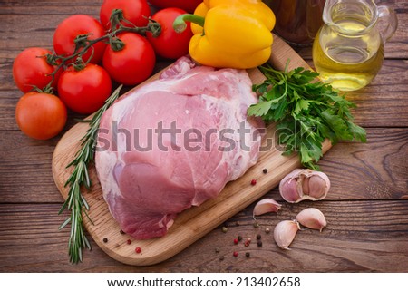 Food. Sliced pieces of raw Meat for barbecue with fresh Vegetables and Mushrooms on wooden surface. Meat Raw Steak. Beef Steak BBQ. Tomatoes, peppers, spices for cooking meat.