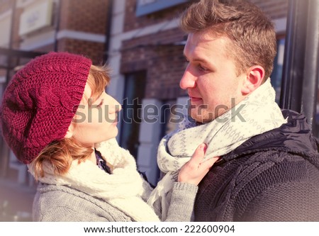 Young people walking around city in winter. Couple in cold winter weather. Love and kiss. Young people. Snow lovers kiss city. Fashion clothing. bright picture of young couple in winter clothes