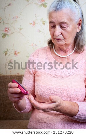 Disease diabetes. Woman testing for high blood sugar. Woman holding device for measuring blood sugar