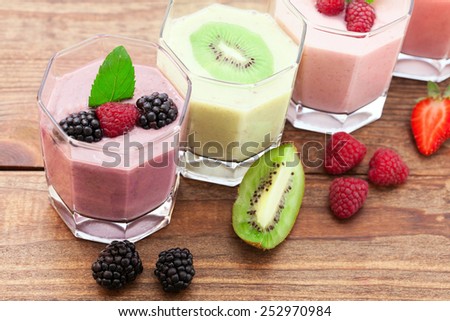 Drink smoothies summer strawberry, blackberry, raspberry on wooden table. Selective focus.