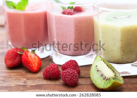 Drink smoothies summer strawberry, blackberry, raspberry on wooden table.