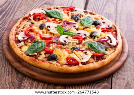 Delicious fresh pizza with seafood. Seafood Italian Pizza slice on wood table horizontal