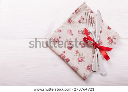 Empty plates and cutlery on table cloth on wooden table for dinner. Top view horizontally.