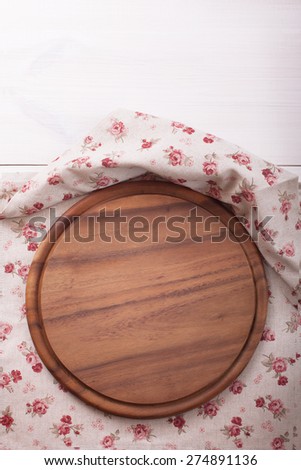 Empty wooden cutting board pizza on linen tablecloths for menu  editing. Wooden texture top view.
