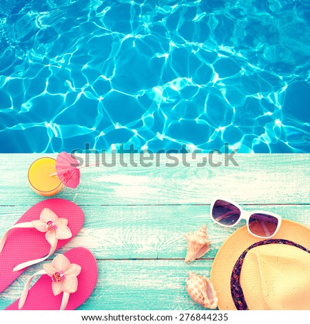 Summer vacation. Pink sandals by swimming pool. Blue sea surface with waves, texture water