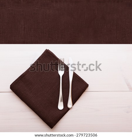 Empty plates and cutlery on table cloth on wooden table for dinner, menu in restaurant Top view square. Flat mock up for design.