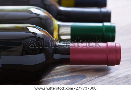Wine bottles close up on wooden desk. Flat mock up for design.