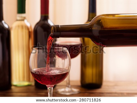 Red wine pouring into wine glass, close-up. Flat mock up for design.
