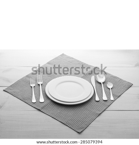 Empty plates and cutlery on table cloth on wooden table for dinner in restaurant. Flat mock up for design menu. Top view.