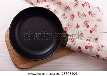 Empty pan on wooden deck table with tablecloth for pizza, product montage. Flat mock up for design. Top view.