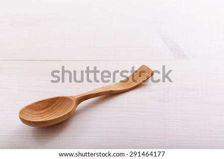 Wooden spoon on white wooden table background