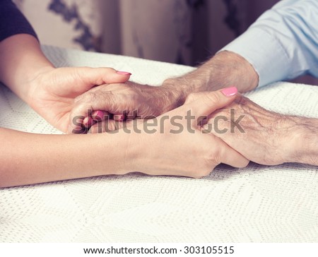 Care is at home of elderly. Space for text. Senior man, with their caregiver at home. Concept of health caring for elderly old people, disabled. Elderly man.